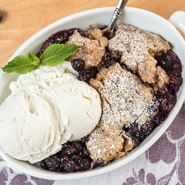 slow cooker blueberry cobbler with vanilla ice cream on top