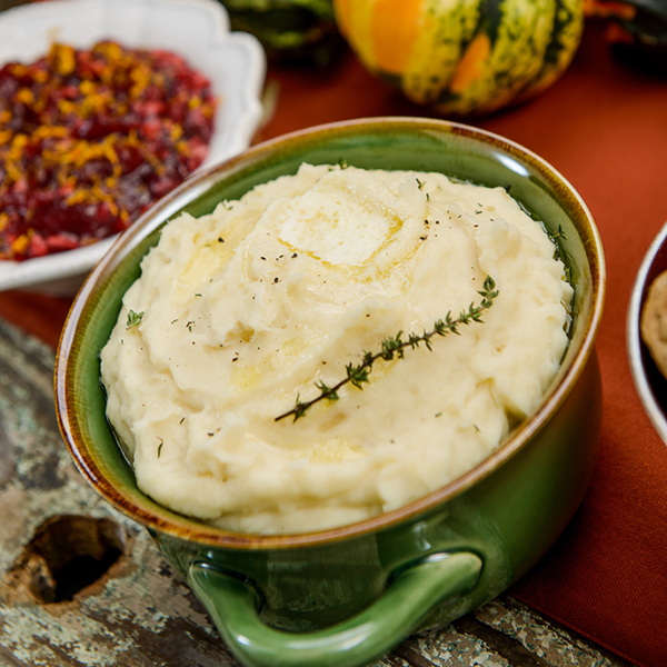 mashed potatoes in a bowl with rosemary